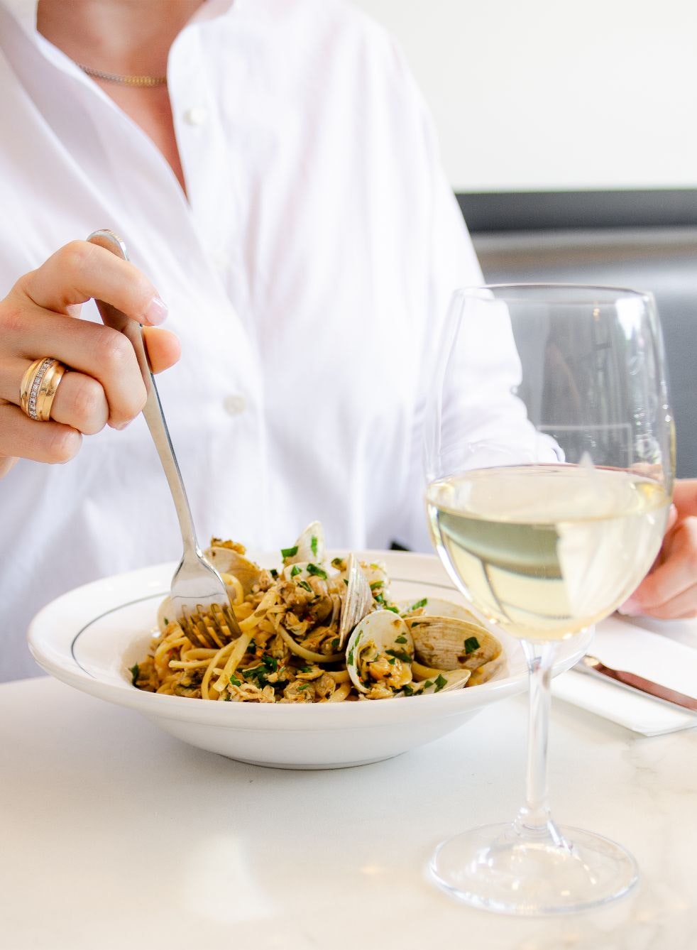 Woman eating pasta at Alessa restaurant