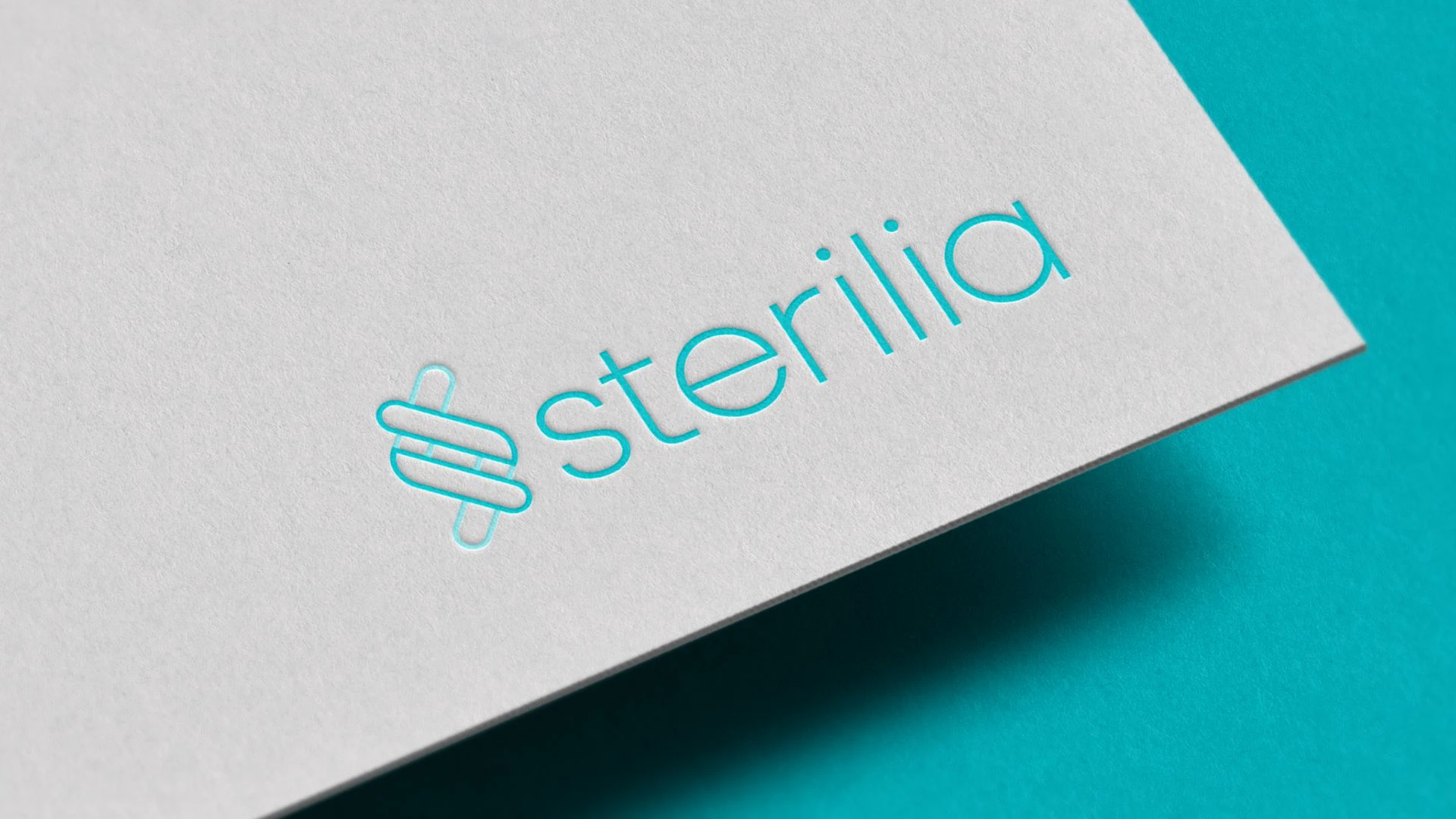 Sterilia business card with an embossed turquoise logo